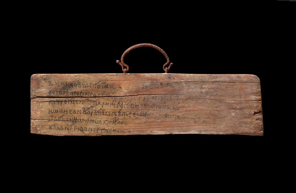 400-500AD, found in Egypt. Wooden board (with iron handle for hanging) with Greek inscription of lines 468-473 from Book I of Homer's Iliad.  © The Trustees of the British Museum. 